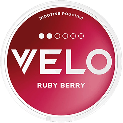 A round container of VELO Ruby Berry nicotine pouches, featuring a vibrant red and pink gradient label with bold white text and a clear plastic rim.